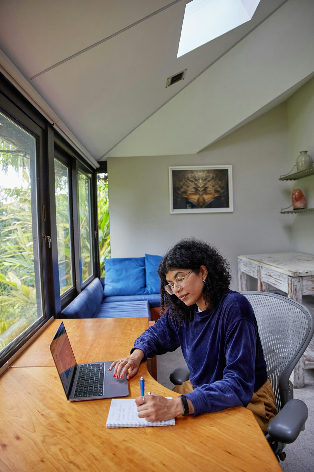 person studying at desk with laptop