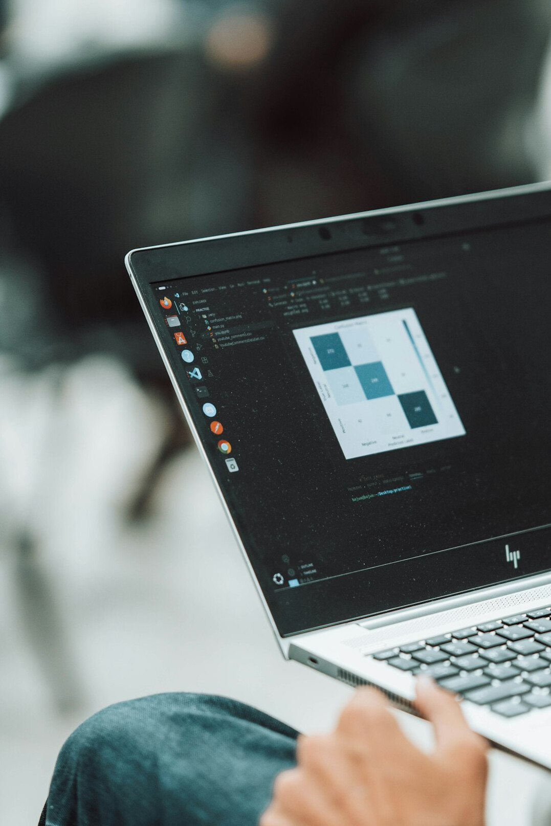 person coding on laptop