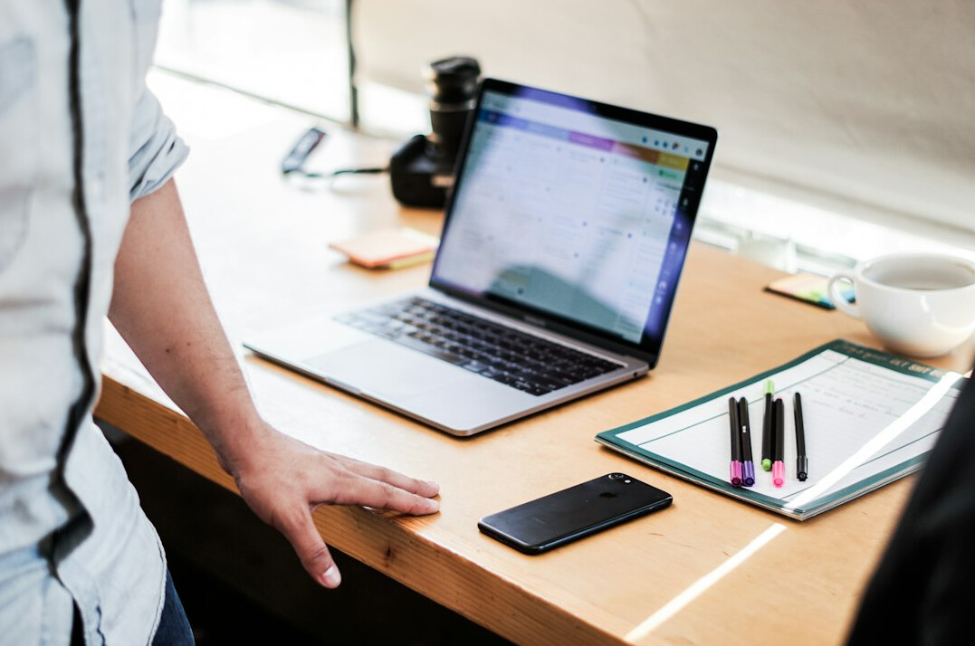 person studying at desk with laptop