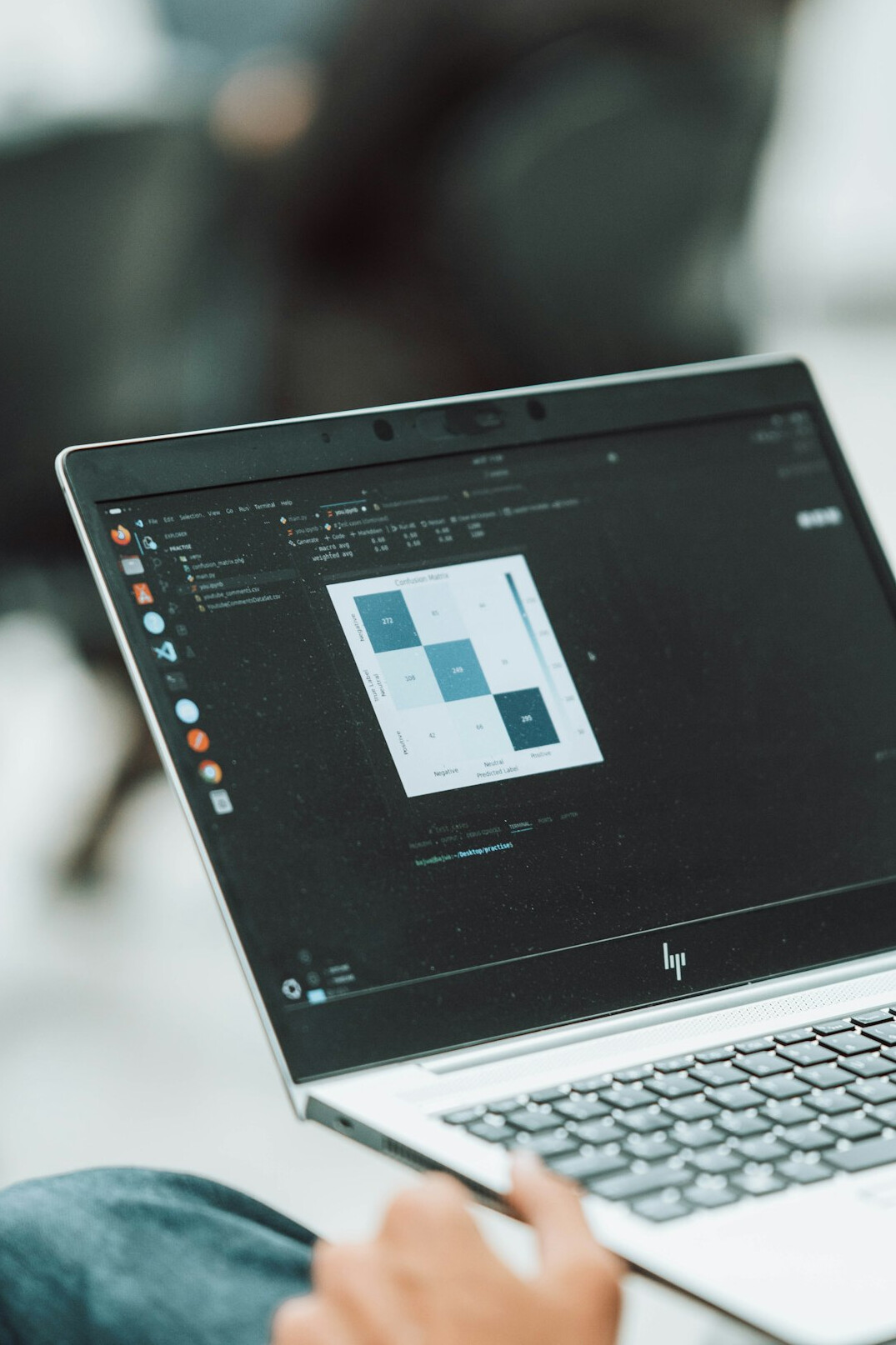 person coding on laptop